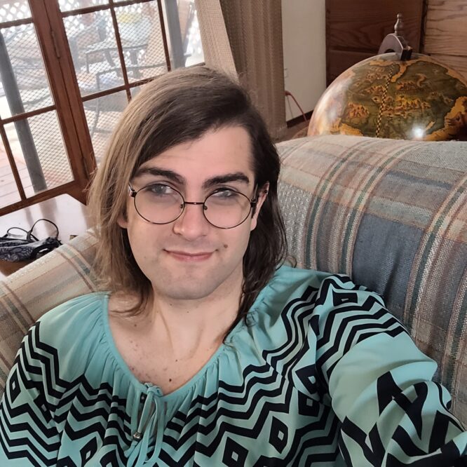 Person with glasses on couch near globe