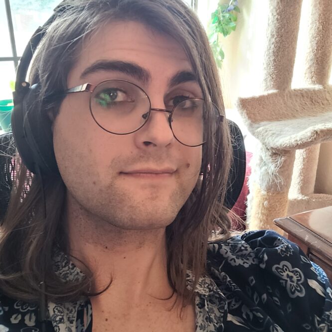Person with glasses and headphones smiling