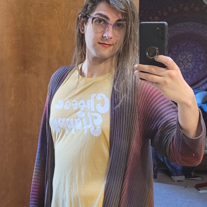 Person mirror selfie wearing glasses and yellow shirt