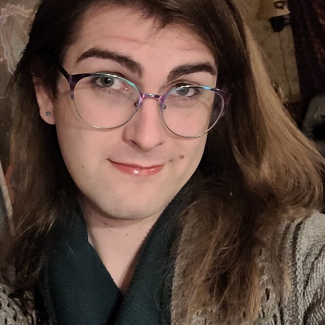 Smiling person with glasses and scarf
