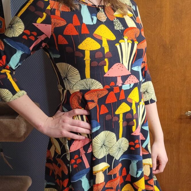 Person wearing colorful mushroom-patterned dress